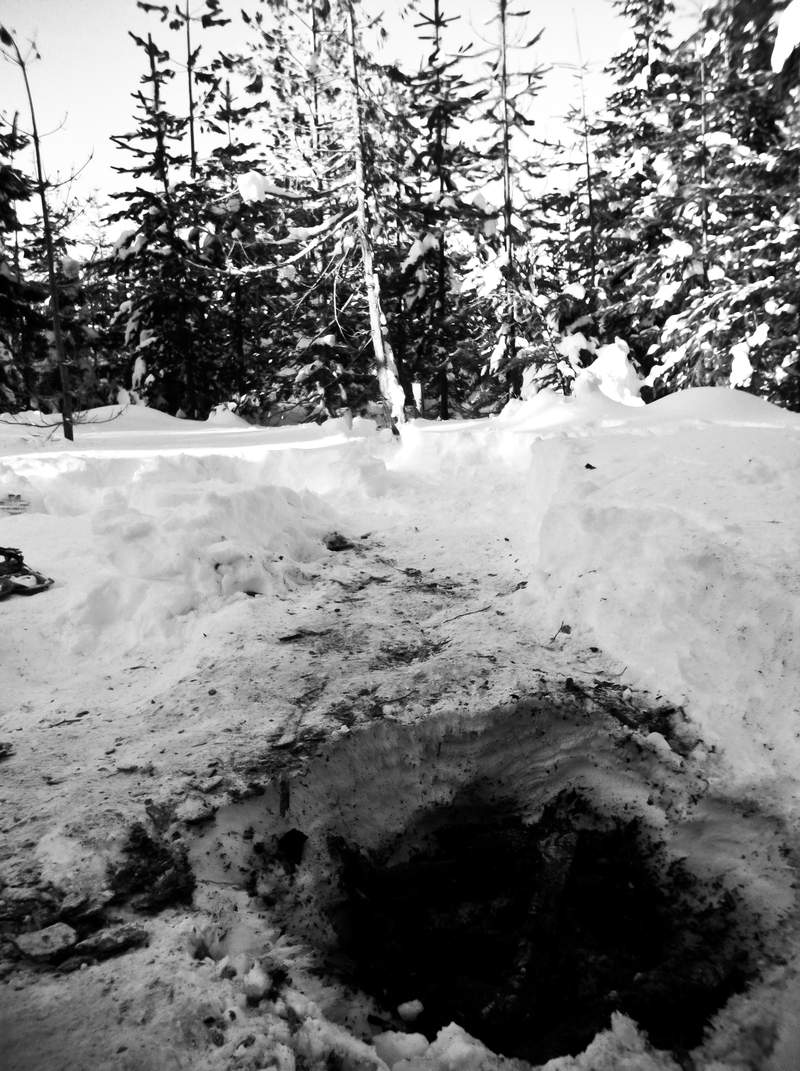 The whole in the snow left from the fire.