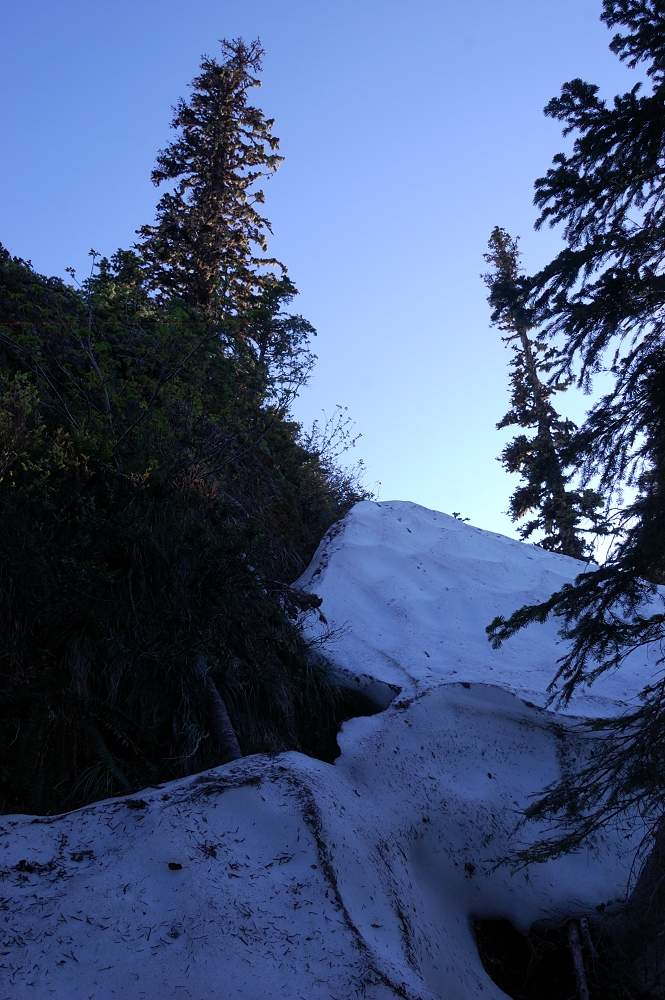 Next I tried to walk around the right side of the rock. We were able to climb this snow drift (10-15 ft high) on east-northeast side all the way to the summit. When this snow drift melts, it's probably a vertical rock there and no easy approach to the sum