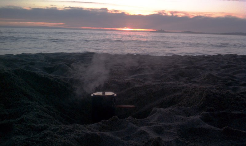 Cooking dinner on the beach while watching the sunset