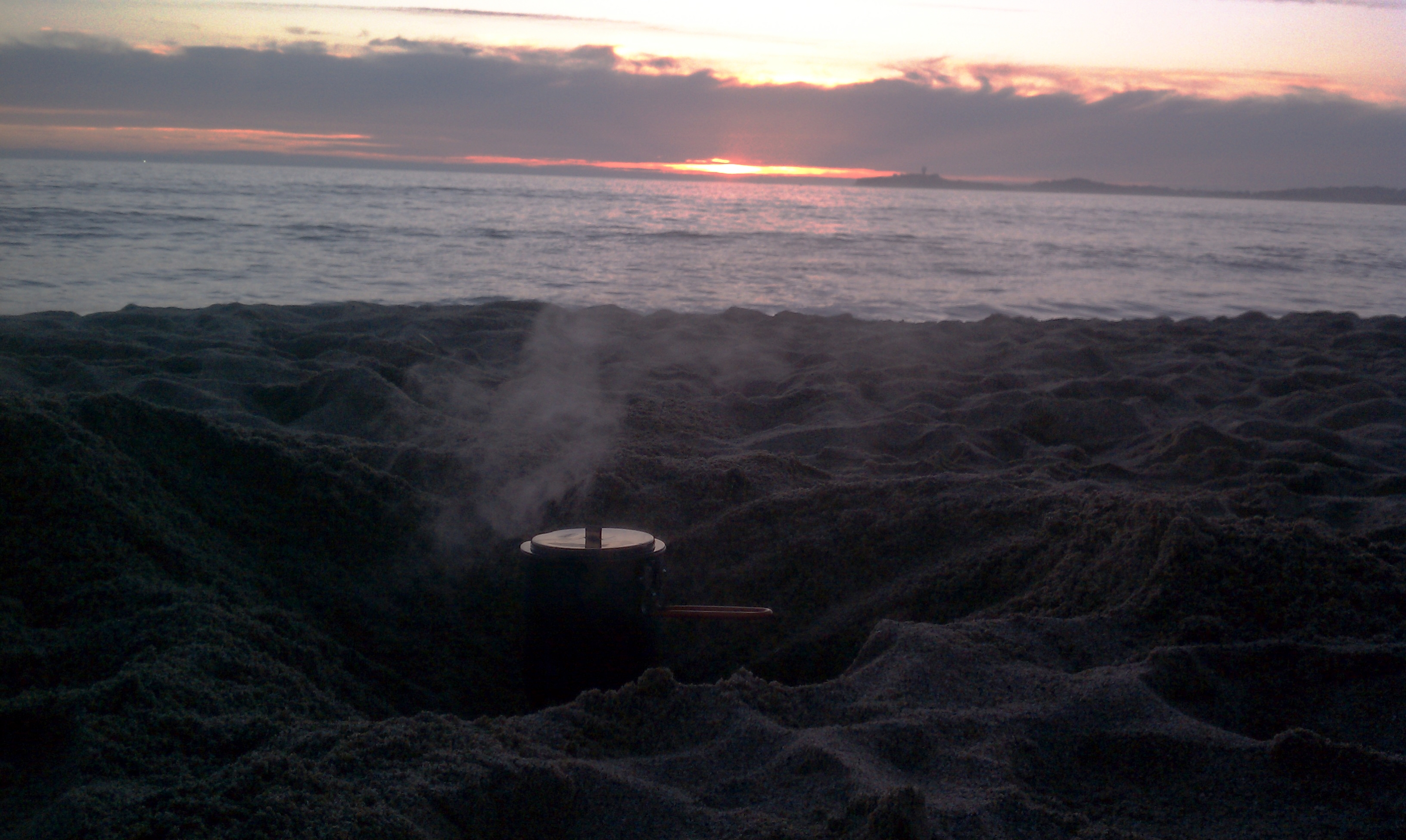 Cooking dinner on the beach while watching the sunset