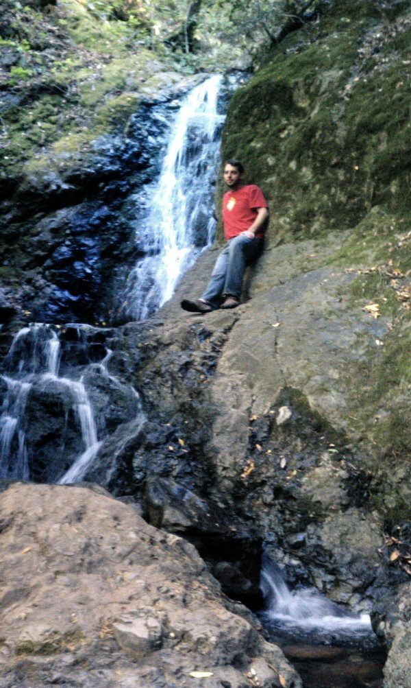 Me sitting by a waterfall