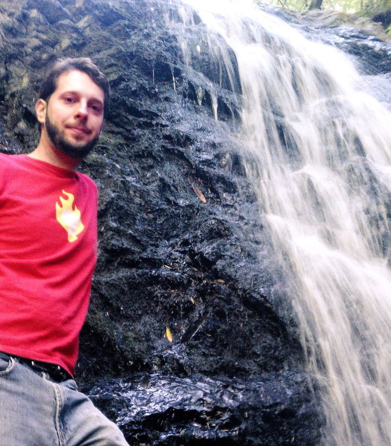 Me standing by a waterfall
